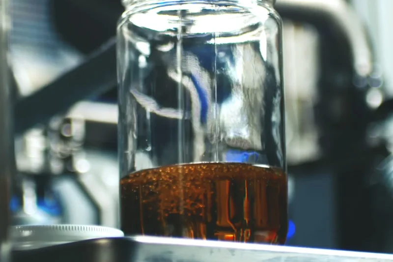 Cannabis extract collected in glass during post-processing distillation